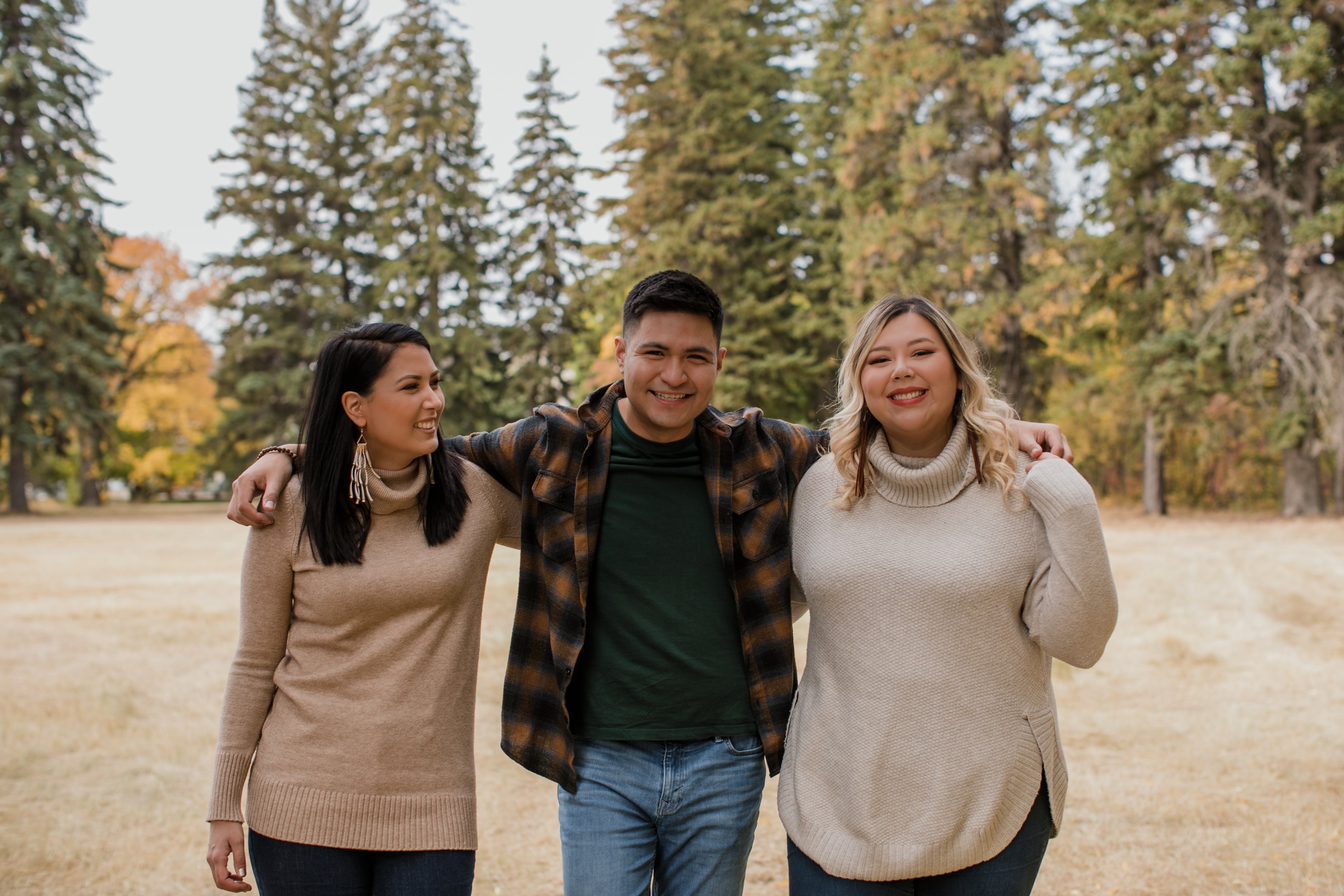 files/three-friends-pose-for-the-camera-in-an-open-field.jpg
